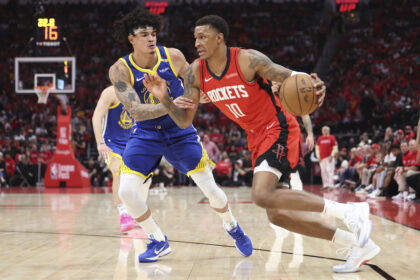 Houston Rockets forward Jabari Smith Jr. (10) drives with the ball as Golden State Warriors forward Gui Santos (15) defends during the third quarter at Toyota Center.