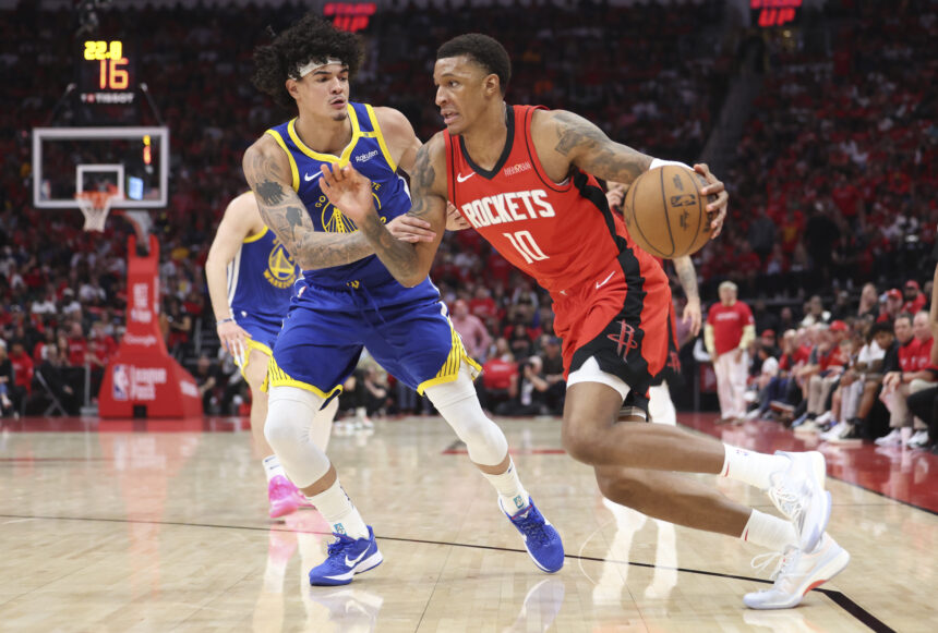 Houston Rockets forward Jabari Smith Jr. (10) drives with the ball as Golden State Warriors forward Gui Santos (15) defends during the third quarter at Toyota Center.