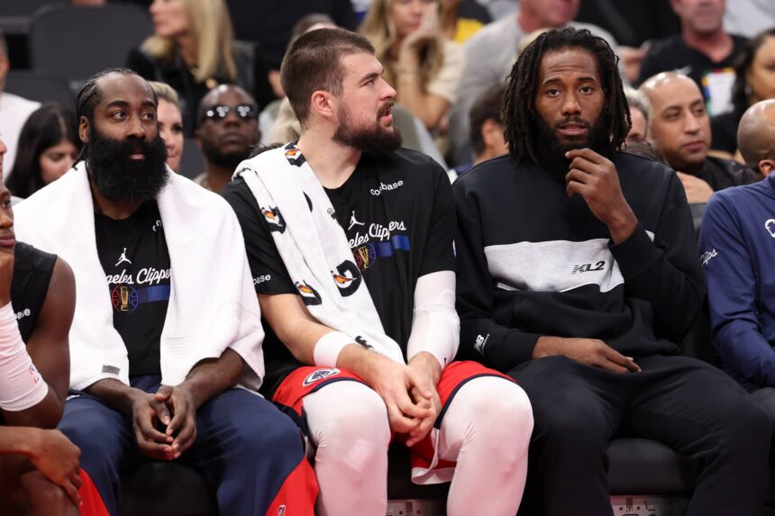 Nov 22, 2024; Inglewood, California, USA; Los Angeles Clippers guard James Harden (1, left) and center Ivica Zubac (40, center) and Kawhi Leonard (right) watch a game from the bench during the second half against the Sacramento Kings at Intuit Dome. Mandatory Credit: Kiyoshi Mio-Imagn Images
