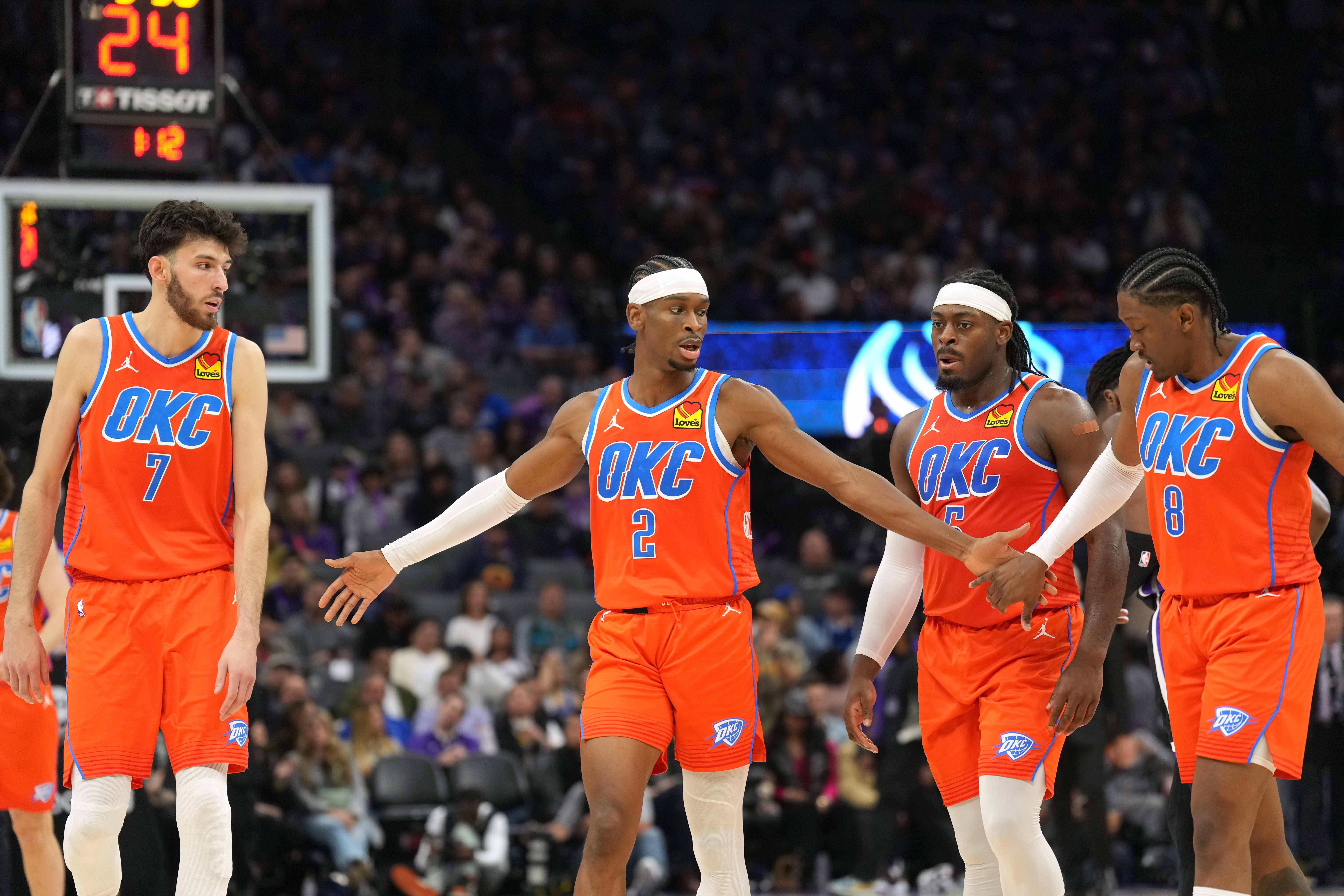 Dec 14, 2023; Sacramento, California, USA; Oklahoma City Thunder guard Shai Gilgeous-Alexander (2) walks to the bench with forwards Chet Holmgren (7) and Jalen Williams (8) and guard Luguentz Dort (second from right) during the fourth quarter against the Sacramento Kings at Golden 1 Center. Mandatory Credit: Darren Yamashita-Imagn Images  