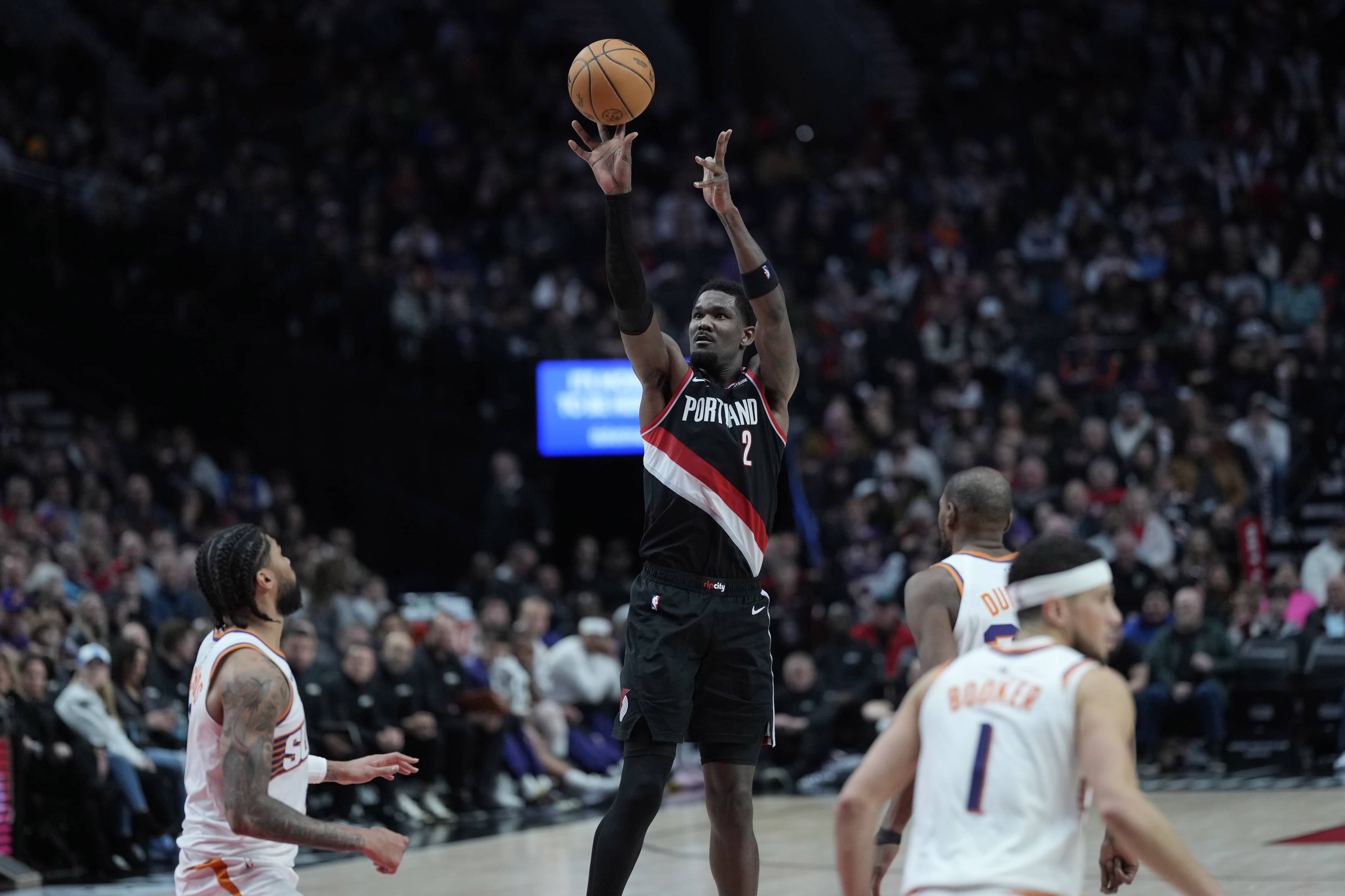 Feb 1, 2025; Portland, Oregon, USA; Portland Trail Blazers center Deandre Ayton (2, left) shoots the ball over Phoenix Suns center Nick Richards (2) during the second half at Moda Center. Mandatory Credit: Soobum Im-Imagn Images