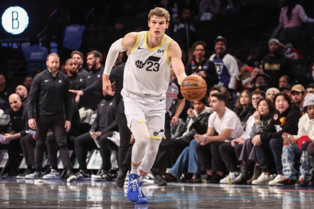 Lauri Markkanen (23) pushes the ball up the court during a game against the Brooklyn Nets.