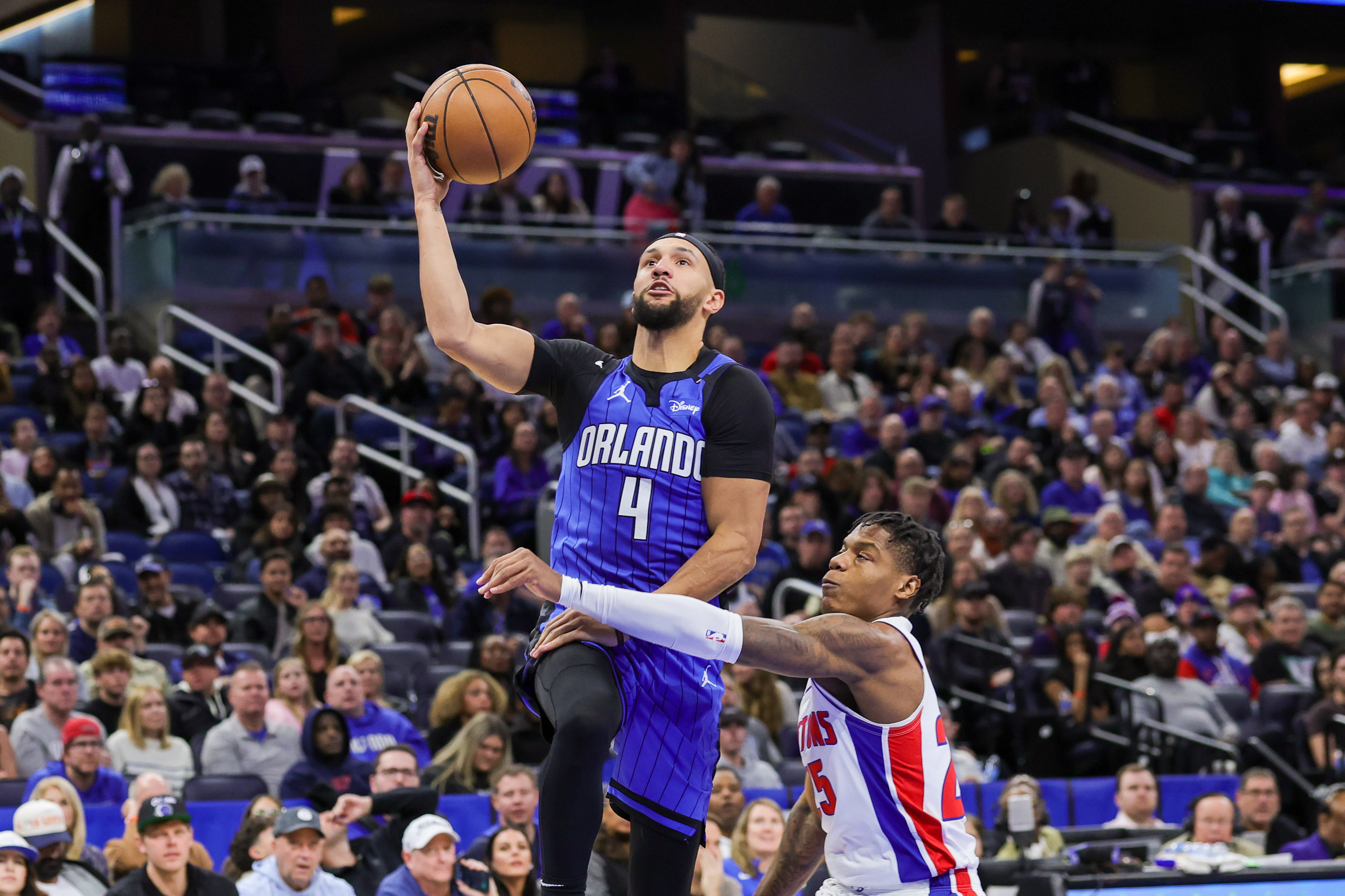 Jan 25, 2025; Orlando, Florida, USA; Orlando Magic guard Jalen Suggs (4) is fouled by Detroit Pistons guard Marcus Sasser (25) during the second half at Kia Center. Mandatory Credit: Mike Watters-Imagn Images