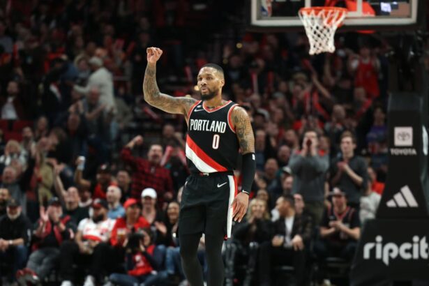 Portland Trail Blazers guard Damian Lillard (0) reacts after shooting a three-point shot over Utah Jazz in the second half at Moda Center.