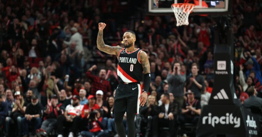 Portland Trail Blazers guard Damian Lillard (0) reacts after shooting a three-point shot over Utah Jazz in the second half at Moda Center.