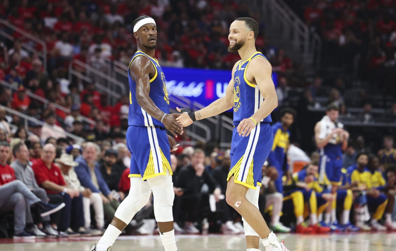 Apr 20, 2025; Houston, Texas, USA; Golden State Warriors guard Stephen Curry (30) celebrates with forward Jimmy Butler III (10) after a play during the second quarter against the Houston Rockets at Toyota Center. Mandatory Credit: Troy Taormina-Imagn Images