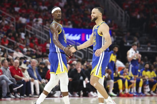 Apr 20, 2025; Houston, Texas, USA; Golden State Warriors guard Stephen Curry (30) celebrates with forward Jimmy Butler III (10) after a play during the second quarter against the Houston Rockets at Toyota Center. Mandatory Credit: Troy Taormina-Imagn Images