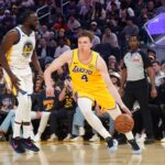 Lakers forward Dalton Knecht dribbles by Warriors forward Draymond Green in the second quarter at Chase Center