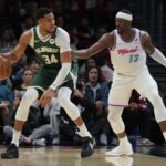 Bucks forward Giannis Antetokounmpo looks to shoot as Heat center Bam Adebayo defends during the first half at Kaseya Center