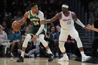 Bucks forward Giannis Antetokounmpo looks to shoot as Heat center Bam Adebayo defends during the first half at Kaseya Center