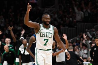 Celtics guard Jaylen Brown reacts to his three point basket against the Timberwolves during the second half at TD Garden