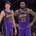 Lakers guard Austin Reaves and forward LeBron James talk on the court against the Nets at Crypto.com Arena