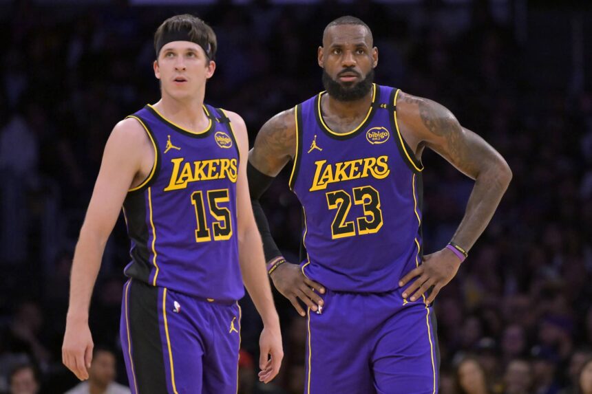 Lakers guard Austin Reaves and forward LeBron James talk on the court against the Nets at Crypto.com Arena