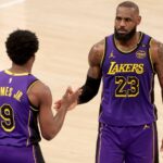 Feb 1, 2025; New York, New York, USA; Los Angeles Lakers guard Bronny James (9) checks in for forward LeBron James (23) during the fourth quarter against the New York Knicks at Madison Square Garden. Mandatory Credit: Brad Penner-Imagn Images