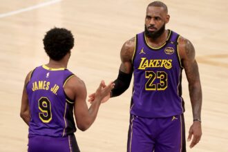 Feb 1, 2025; New York, New York, USA; Los Angeles Lakers guard Bronny James (9) checks in for forward LeBron James (23) during the fourth quarter against the New York Knicks at Madison Square Garden. Mandatory Credit: Brad Penner-Imagn Images
