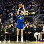 Warriors guard Pat Spencer takes a three-point shot against the Mavericks during the fourth quarter at Chase Center