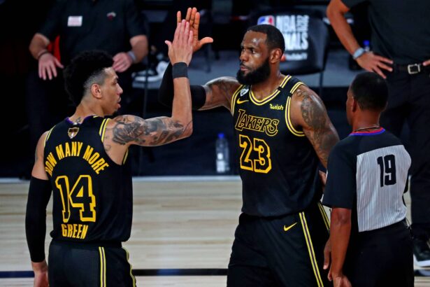 Oct 2, 2020; Orlando, Florida, USA; Los Angeles Lakers forward LeBron James (23) celebrates with guard Danny Green (14) after a play during the third quarter against the Miami Heat in game two of the 2020 NBA Finals at AdventHealth Arena. Mandatory Credit: Kim Klement-Imagn Images