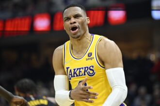 Mar 21, 2022; Cleveland, Ohio, USA; Los Angeles Lakers guard Russell Westbrook (0) reacts in the second quarter against the Cleveland Cavaliers at Rocket Mortgage FieldHouse. Mandatory Credit: David Richard-USA TODAY Sports
