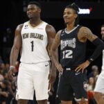 Nov 25, 2022; Memphis, Tennessee, USA; New Orleans Pelicans forward Zion Williamson (1) and Memphis Grizzlies guard Ja Morant (12) talk during free throws during the second half at FedExForum. Mandatory Credit: Petre Thomas-Imagn Images