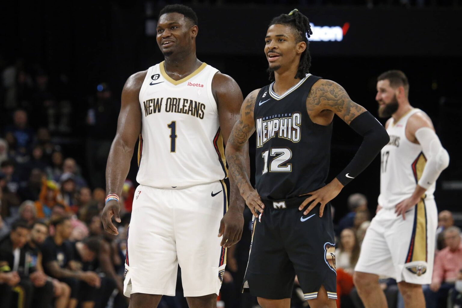 Nov 25, 2022; Memphis, Tennessee, USA; New Orleans Pelicans forward Zion Williamson (1) and Memphis Grizzlies guard Ja Morant (12) talk during free throws during the second half at FedExForum. Mandatory Credit: Petre Thomas-Imagn Images