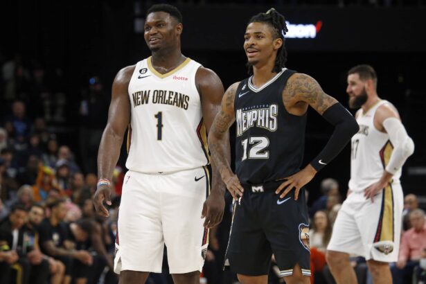 Nov 25, 2022; Memphis, Tennessee, USA; New Orleans Pelicans forward Zion Williamson (1) and Memphis Grizzlies guard Ja Morant (12) talk during free throws during the second half at FedExForum. Mandatory Credit: Petre Thomas-Imagn Images