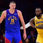 Apr 25, 2024; Los Angeles, California, USA; Denver Nuggets center Nikola Jokic (15) controls the ball against Los Angeles Lakers forward LeBron James (23) during the second half in game three of the first round for the 2024 NBA playoffs at Crypto.com Arena. Mandatory Credit: Gary A. Vasquez-Imagn Images
