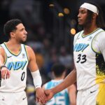 Dec 8, 2024; Indianapolis, Indiana, USA; Indiana Pacers guard Tyrese Haliburton (0) and Indiana Pacers center Myles Turner (33) talk during a timeout during the first half against the Charlotte Hornets at Gainbridge Fieldhouse. Mandatory Credit: Robert Goddin-Imagn Images