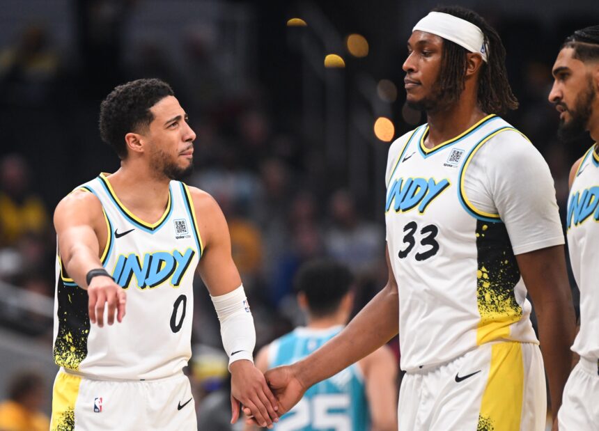 Dec 8, 2024; Indianapolis, Indiana, USA; Indiana Pacers guard Tyrese Haliburton (0) and Indiana Pacers center Myles Turner (33) talk during a timeout during the first half against the Charlotte Hornets at Gainbridge Fieldhouse. Mandatory Credit: Robert Goddin-Imagn Images