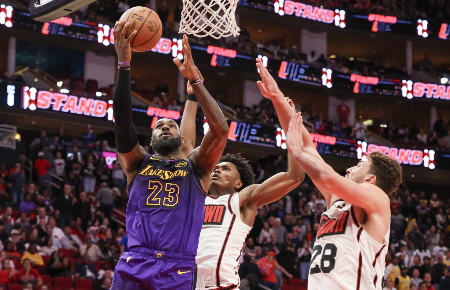 Jan 5, 2025; Houston, Texas, USA; Los Angeles Lakers forward LeBron James (23) makes a basket against Houston Rockets center Alperen Sengun (28) in the fourth quarter at Toyota Center. Mandatory Credit: Thomas Shea-Imagn Images