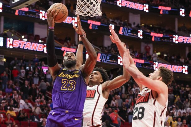 Jan 5, 2025; Houston, Texas, USA; Los Angeles Lakers forward LeBron James (23) makes a basket against Houston Rockets center Alperen Sengun (28) in the fourth quarter at Toyota Center. Mandatory Credit: Thomas Shea-Imagn Images