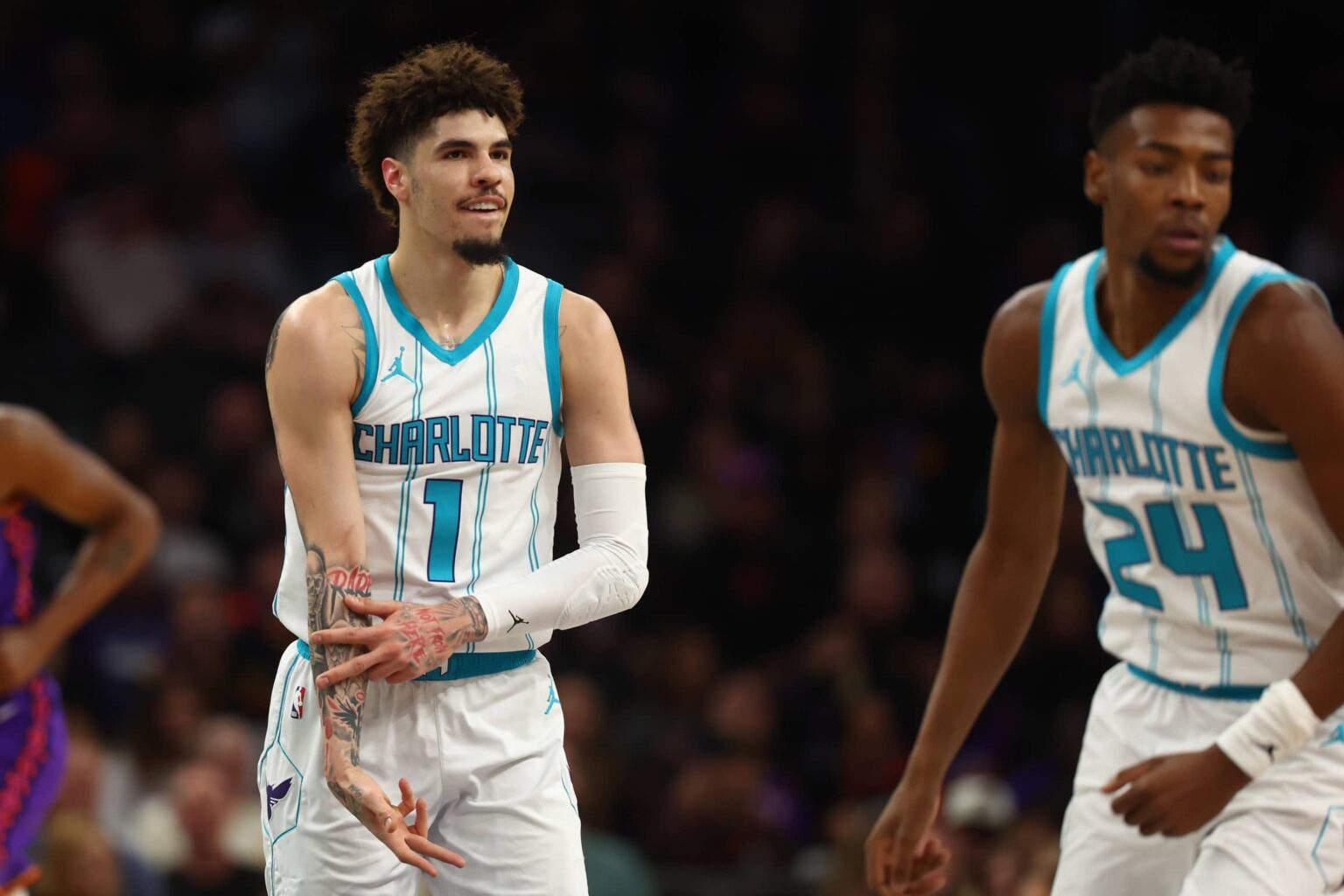 Jan 12, 2025; Phoenix, Arizona, USA; Charlotte Hornets guard LaMelo Ball (1) reacts after a basket against the Phoenix Suns during the first half at Footprint Center. Mandatory Credit: Mark J. Rebilas-Imagn Images