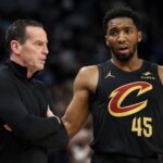Jan 18, 2025; Minneapolis, Minnesota, USA; Cleveland Cavaliers guard Donovan Mitchell (45) talks with head coach Kenny Atkinson during the second quarter against the Minnesota Timberwolves at Target Center. Mandatory Credit: Matt Krohn-Imagn Images