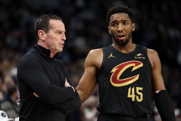 Jan 18, 2025; Minneapolis, Minnesota, USA; Cleveland Cavaliers guard Donovan Mitchell (45) talks with head coach Kenny Atkinson during the second quarter against the Minnesota Timberwolves at Target Center. Mandatory Credit: Matt Krohn-Imagn Images