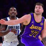 Feb 25, 2025; Los Angeles, California, USA; Los Angeles Lakers guard Luka Doncic (77) and Dallas Mavericks guard Kyrie Irving (11) attempt to gain control during the first quarter at Crypto.com Arena. Mandatory Credit: Gary A. Vasquez-Imagn Images