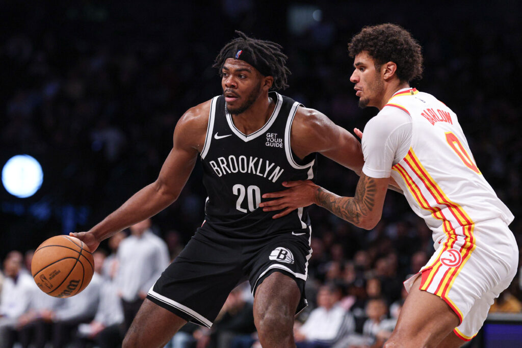 Mar 16, 2025; Brooklyn, New York, USA; Brooklyn Nets center Day'Ron Sharpe (20) is defended by Atlanta Hawks forward Dominick Barlow (0) during the second half at Barclays Center. Mandatory Credit: Vincent Carchietta-Imagn Images