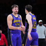 Mar 17, 2025; Los Angeles, California, USA; Los Angeles Lakers guard Luka Doncic (77) and guard Austin Reaves (15) react against the San Antonio Spurs in the first half at Crypto.com Arena. Mandatory Credit: Kirby Lee-Imagn Images