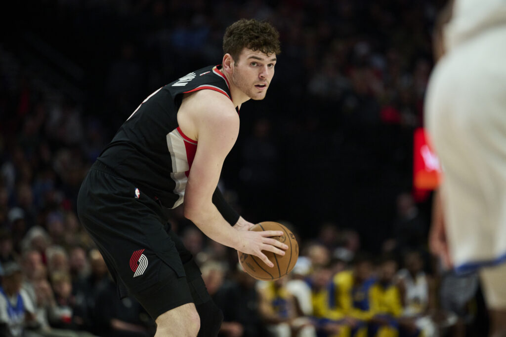 Apr 11, 2025; Portland, Oregon, USA; Portland Trail Blazers center Donovan Clingan (23) looks to pass the ball during the second half against the Golden State Warriors at Moda Center. Mandatory Credit: Troy Wayrynen-Imagn Images