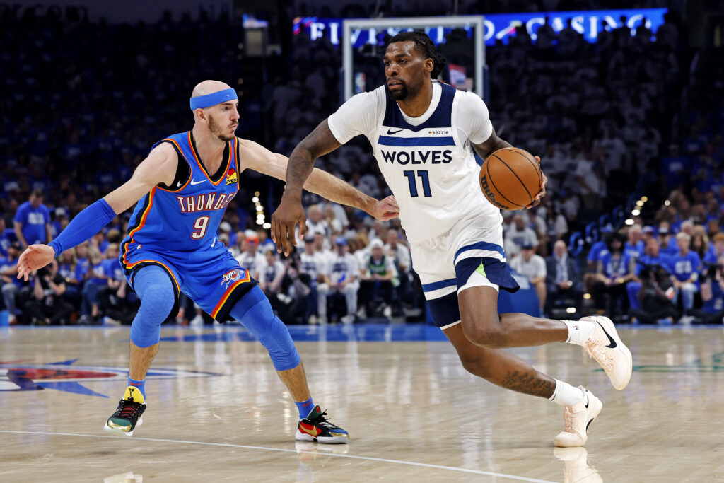May 28, 2025; Oklahoma City, Oklahoma, USA; Minnesota Timberwolves center Naz Reid (11) drives to the basket against Oklahoma City Thunder guard Alex Caruso (9) during the second quarter in game five of the western conference finals for the 2025 NBA Playoffs at Paycom Center. Mandatory Credit: Alonzo Adams-Imagn Images