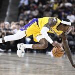 Oct 3, 2025; Palm Desert, California, USA; Los Angeles Lakers forward Jarred Vanderbilt (2) dives for a loose ball during the first half against the Phoenix Suns at Acrisure Arena. Mandatory Credit: Denis Poroy-Imagn Images