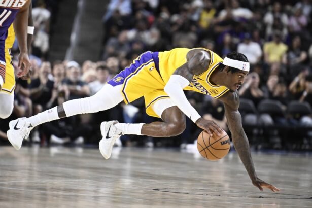 Oct 3, 2025; Palm Desert, California, USA; Los Angeles Lakers forward Jarred Vanderbilt (2) dives for a loose ball during the first half against the Phoenix Suns at Acrisure Arena. Mandatory Credit: Denis Poroy-Imagn Images