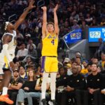 Oct 5, 2025; San Francisco, California, USA; Los Angeles Lakers forward Dalton Knecht (4) shoots while defended by Golden State Warriors guard Buddy Hield (7) in the second quarter at Chase Center. Mandatory Credit: David Gonzales-Imagn Images