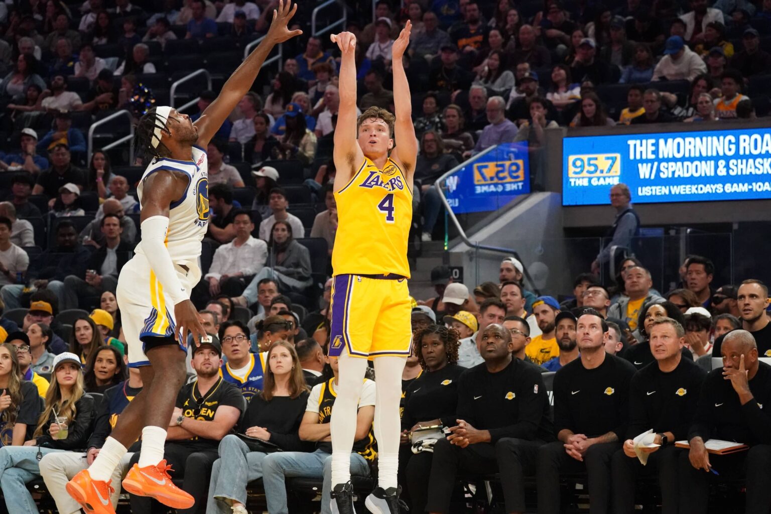 Oct 5, 2025; San Francisco, California, USA; Los Angeles Lakers forward Dalton Knecht (4) shoots while defended by Golden State Warriors guard Buddy Hield (7) in the second quarter at Chase Center. Mandatory Credit: David Gonzales-Imagn Images