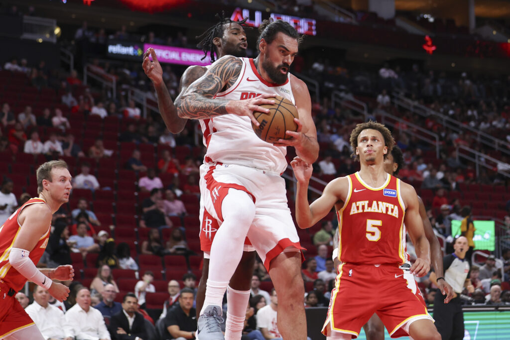 Oct 6, 2025; Houston, Texas, USA; Houston Rockets center Steven Adams (12) grabs a rebound during the third quarter against the Atlanta Hawks at Toyota Center. Mandatory Credit: Troy Taormina-Imagn Images