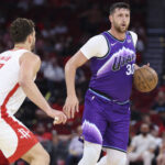 Oct 8, 2025; Houston, Texas, USA; Utah Jazz center Jusuf Nurkic (30) controls the ball as Houston Rockets center Alperen Sengun (28) defends during the first quarter at Toyota Center. Mandatory Credit: Troy Taormina-Imagn Images