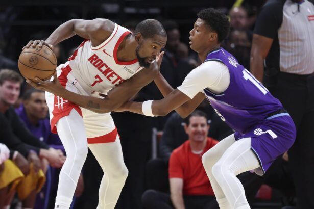 Oct 8, 2025; Houston, Texas, USA; Houston Rockets forward Kevin Durant (7) controls the ball as Utah Jazz forward Ace Bailey (19) defends during the second quarter at Toyota Center. Mandatory Credit: Troy Taormina-Imagn Images