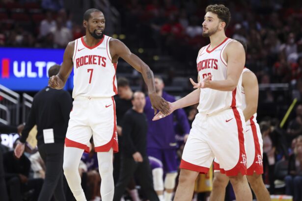 Oct 8, 2025; Houston, Texas, USA; Houston Rockets forward Kevin Durant (7) reacts with center Alperen Sengun (28) after a play during the third quarter against the Utah Jazz at Toyota Center. Mandatory Credit: Troy Taormina-Imagn Images