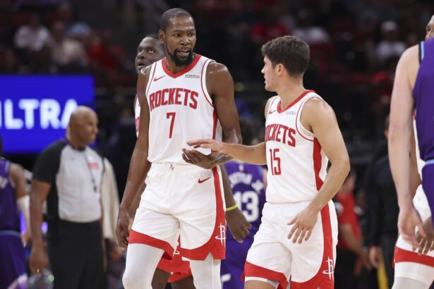 Oct 8, 2025; Houston, Texas, USA; Houston Rockets forward Kevin Durant (7) talks with guard Reed Sheppard (15) after a play during the third quarter against the Utah Jazz at Toyota Center. Mandatory Credit: Troy Taormina-Imagn Images