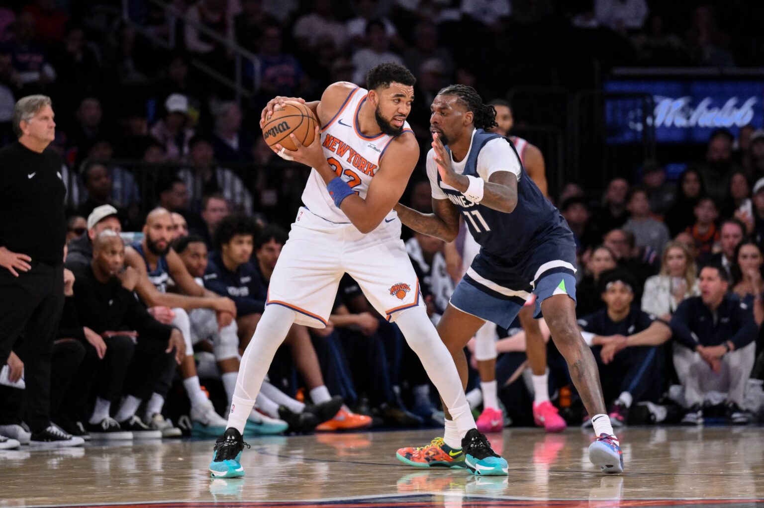 Oct 9, 2025; New York, New York, USA; New York Knicks center/forward Karl-Anthony Towns (32) looks for an opening as Minnesota Timberwolves center/forward Naz Reid (11) defends during the first half at Madison Square Garden. Mandatory Credit: John Jones-Imagn Images