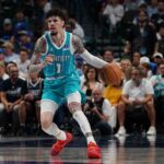 Hornets guard Lamelo Ball brings the ball up court against the Mavericks in the first half of a game at American Airlines Center