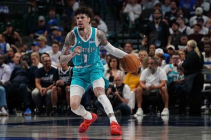 Hornets guard Lamelo Ball brings the ball up court against the Mavericks in the first half of a game at American Airlines Center